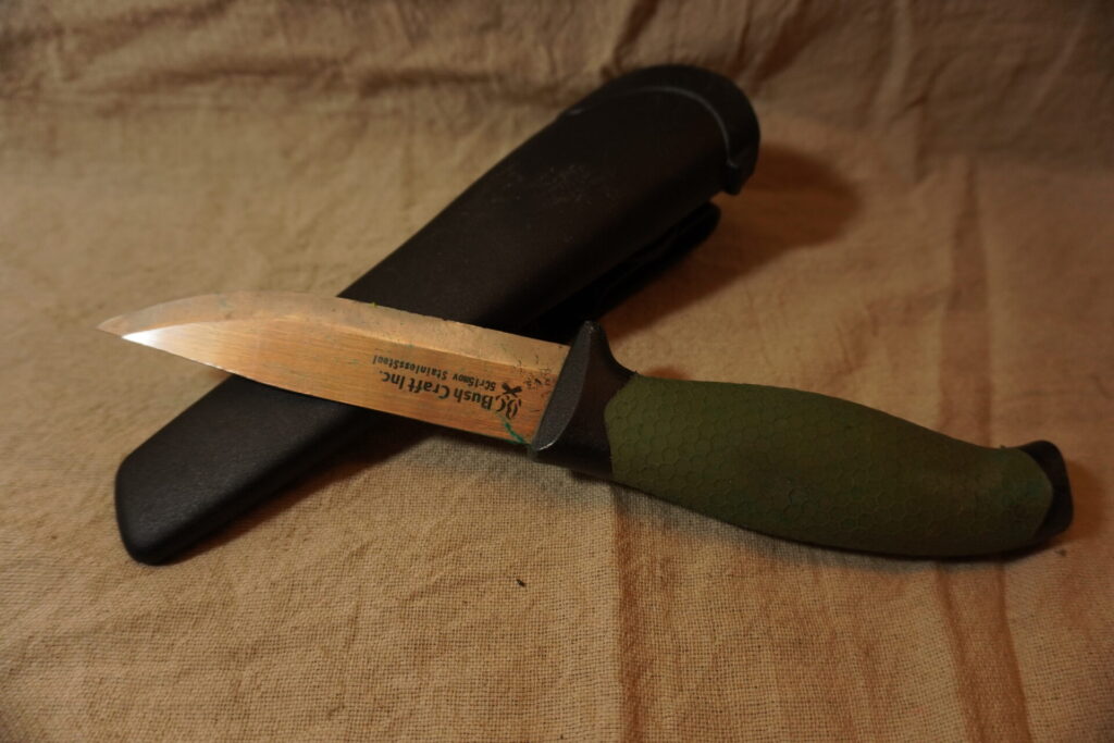 キャンプ用の緑色の鞘付きアウトドアナイフ